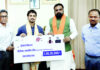 Bihar CM Samrat Choudhary handing over a cheque of Rs 1 crore to Ishan Kishan.