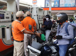 Commuters at a petrol pump in Jammu on Friday. (UNI)