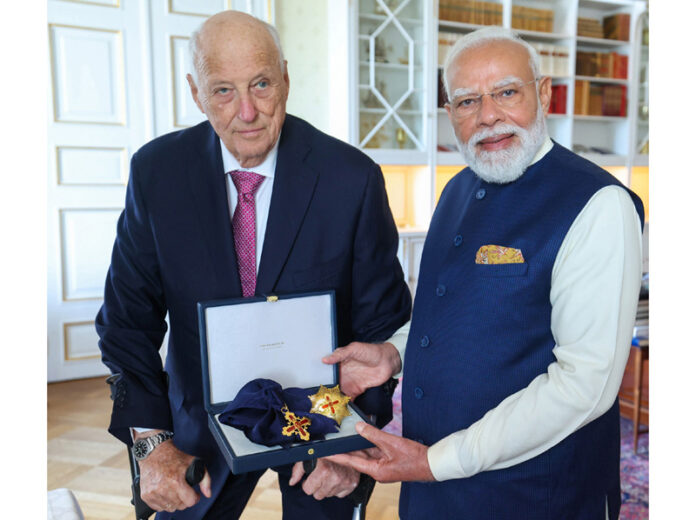 Prime Minister, Narendra Modi being conferred with the highest honour- Grand Cross of the Royal Norwegian Order of Merit, in Norway on Monday. (UNI)