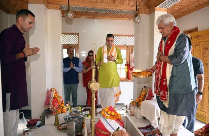 LG Manoj Sinha offers prayers at the temple on Monday.