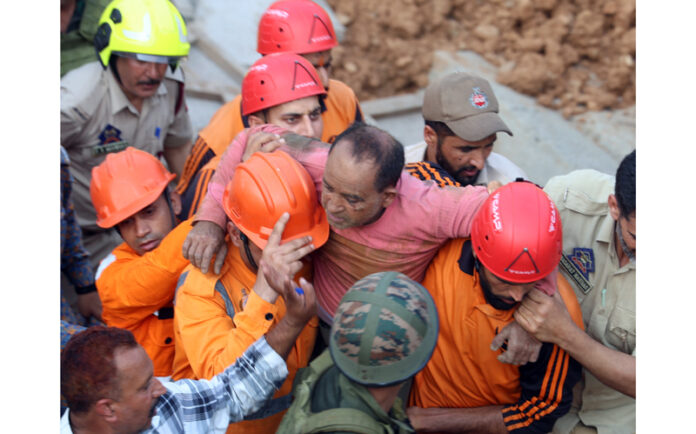 An injured labourer being rescued by NDRF, SDRF and local police personnel at Thathar area. — Excelsior/Rakesh