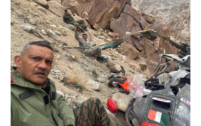 Senior Army officer takes selfie with damaged helicopter and injured officers in background. Senior Army officer takes selfie with damaged helicopter and injured officers in background.