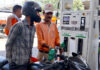 Commuters queue up at a petrol pump in Jammu on Monday.