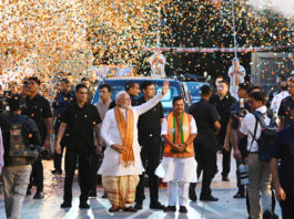 Prime Minister Narendra Modi greets his supporters as he arrives at the BJP headquarters in New Delhi on Monday. (UNI)