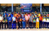 Teams posing along with dignitaries during a cricket match at MA Stadium.