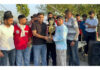 Congress leader Neeraj Kundan presenting title trophy to captain of Dablehar team.