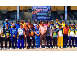 Teams posing along with dignitaries during a cricket match at MA Stadium.