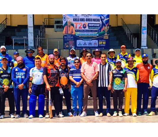 Teams posing along with dignitaries during a cricket match at MA Stadium.