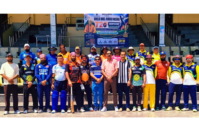 Teams posing along with dignitaries during a cricket match at MA Stadium.