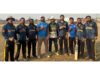 Winning team posing for a group photograph.