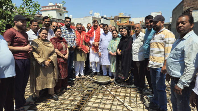 MLA Arvind Gupta inaugurating work of laying slab of community hall in Jammu.