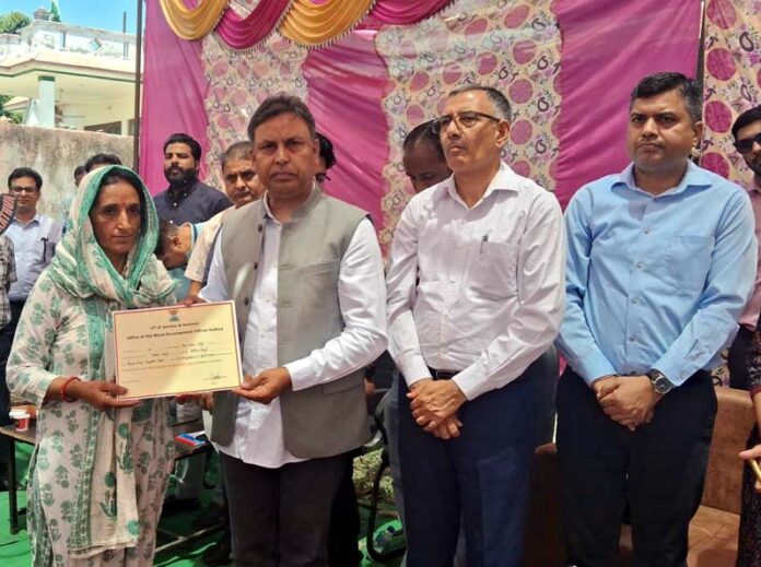 MLA, Kathua, Dr Bharat Bhushan handing over sanction letter of relief to a flood hit victim in Kathua on Wednesday.