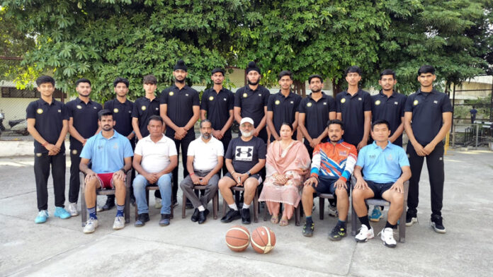 J&K Junior Basketball team posing along with dignitaries during a programme.