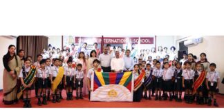 Students of Shaurya International School posing with guests and management.