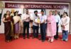 Dr Narinder Singh Raina, MLA, RS Pura, felicitating a student during a programme.