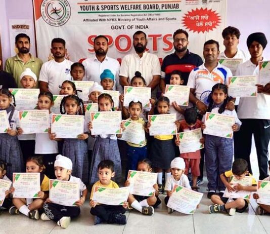 Dignitaries posing along with students during a programme.
