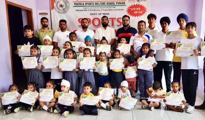 Dignitaries posing along with students during a programme.