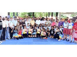 Players posing along with dignitaries during an event.