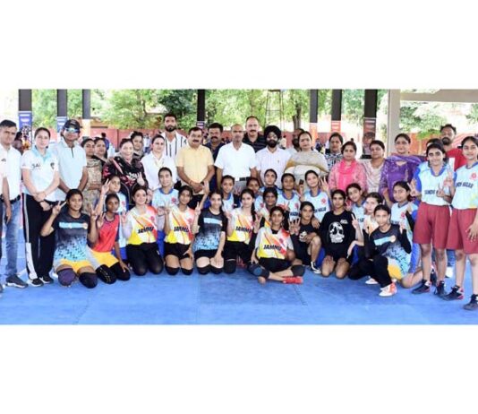 Players posing along with dignitaries during an event.