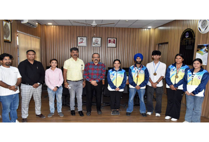 University management posing along with outstanding sportspersons.