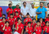 Dignitaries posing along with selected athletes during a programme.