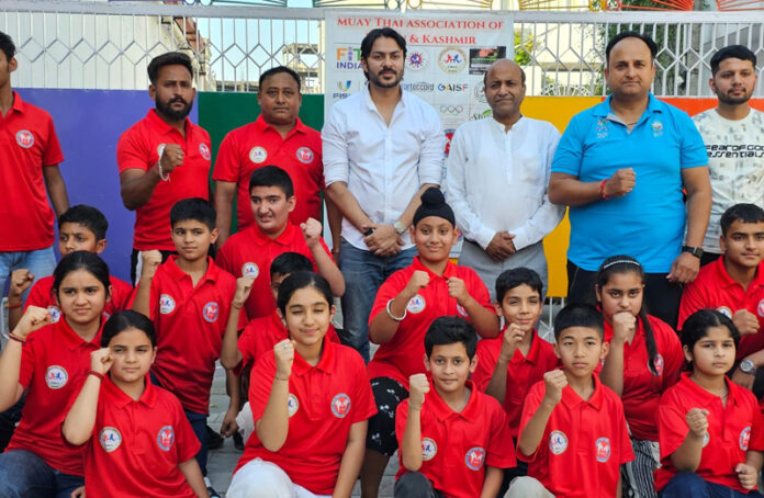 Dignitaries posing along with selected athletes during a programme.