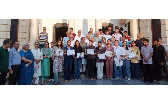Meritorious students posing along with dignitaries during a programme. Meritorious students posing along with dignitaries during a programme.