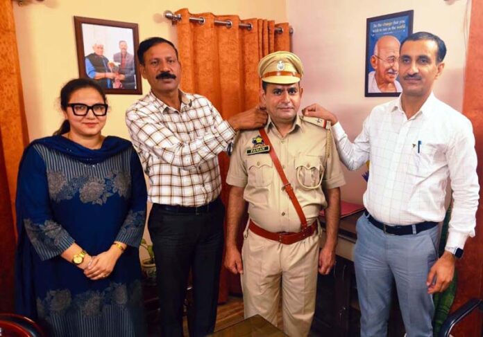 Deputy Director Prosecution Jammu Rajesh Gill, along with Senior Prosecutor Altaf Hussain, decorating a promoted official.