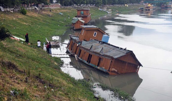 Partially sunk houseboat in Jhelum River in Srinagar. -Excelsior/Shakeel Partially sunk houseboat in Jhelum River in Srinagar. -Excelsior/Shakeel