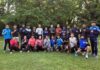 Participating Wushu athletes posing with their coach for a group photograph during the National Wushu Coaching Camp at SKISC Srinagar.