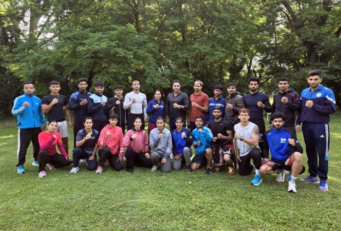 Participating Wushu athletes posing with their coach for a group photograph during the National Wushu Coaching Camp at SKISC Srinagar.