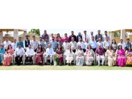 Dignitaries posing along with school management during a programme.