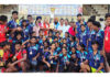 Winning team receiving trophy from dignitaries.