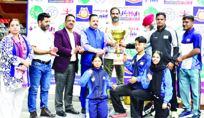 Winning team posing along with trophy during prize distribution ceremony.