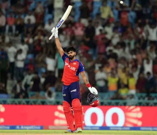 Shreyas Iyer raising his bat after scoring an unbeaten 101 runs against LSG in Lucknow on Saturday.