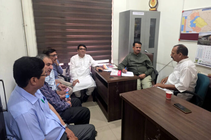 Rakesh Mahajan listening to public grievances at BJP office.