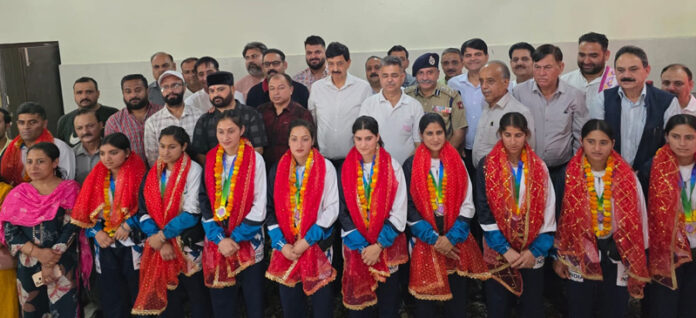 International medal-winning girls with dignitaries during a ceremony in Udhampur.