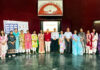 Dignitaries posing along with school management during a programme.