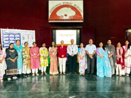 Dignitaries posing along with school management during a programme.