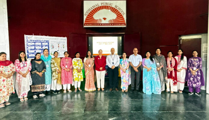 Dignitaries posing along with school management during a programme.