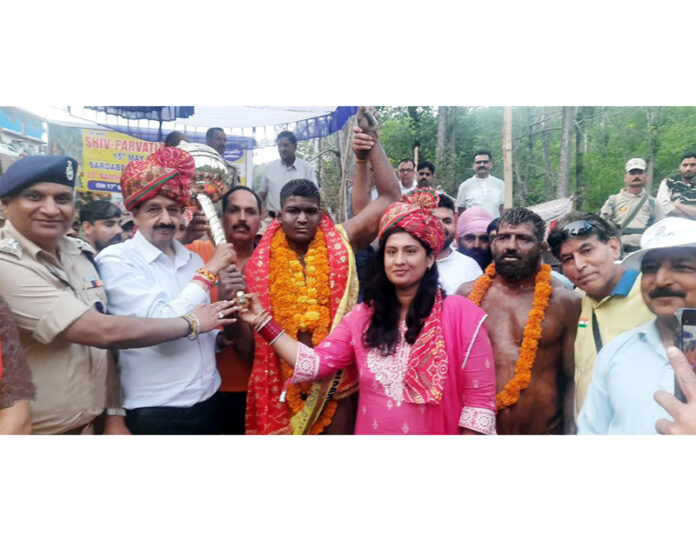 MLA Udhampur West Pawan Kumar Gupta and others posing along with wrestler.