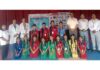 Students posing along with AYUSH staff and school management.
