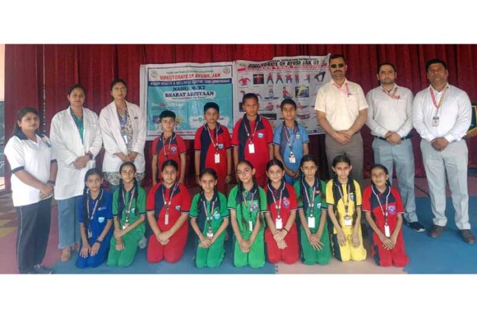 Students posing along with AYUSH staff and school management.