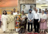 Participants posing for a group photograph along with dignitaries during a programme.