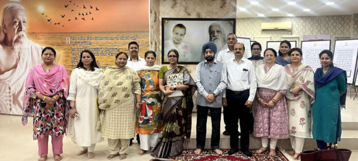 Participants posing for a group photograph along with dignitaries during a programme.