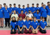 Selected fencing team posing along with support staff.