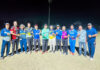 Winning team posing for a group photograph.