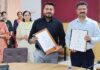 Representatives of DET and GCC Gurha Slathia displaying signed MoU during a programme.