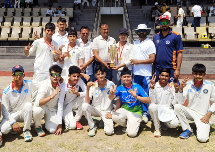 Winning team posing along with trophy. Winning team posing along with trophy.