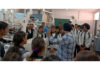 An expert demonstrating scientific experiments to students during their educational visit to IIT Jammu.